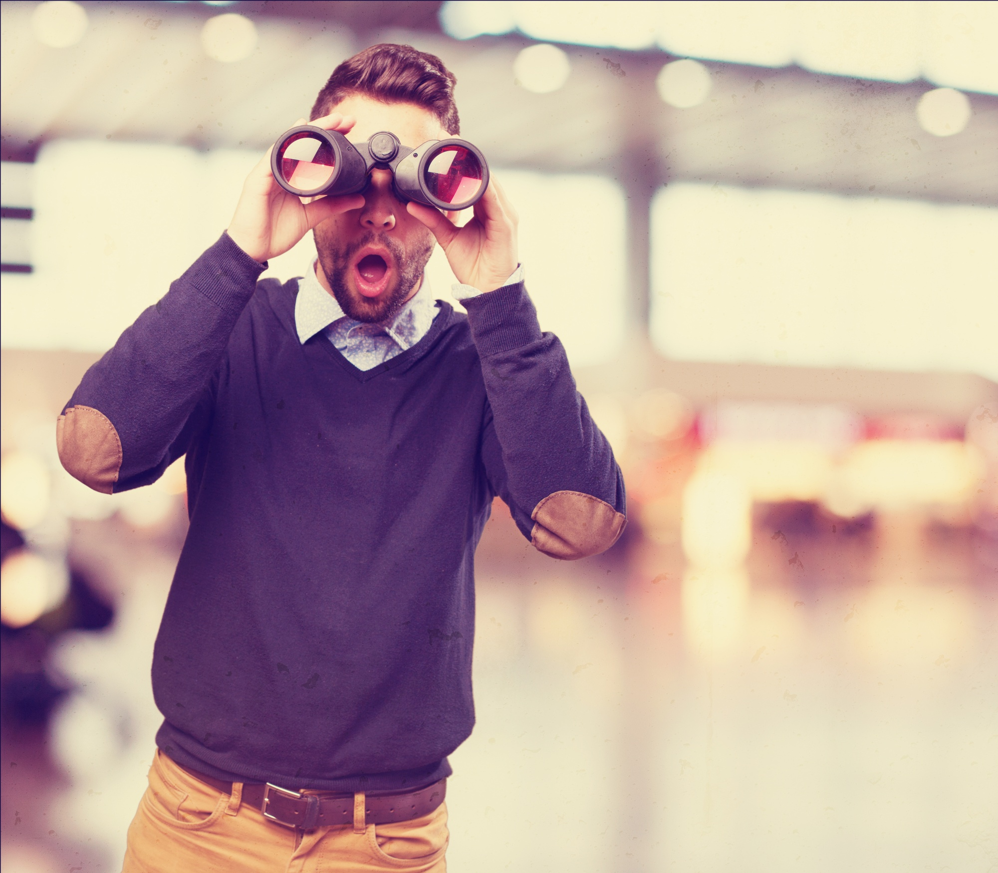 surprised-man-looking-through-binoculars